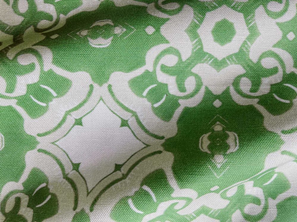 A fabric swatch of Pearl & Maude's medallion pattern Alexandria in moss green, cream and white