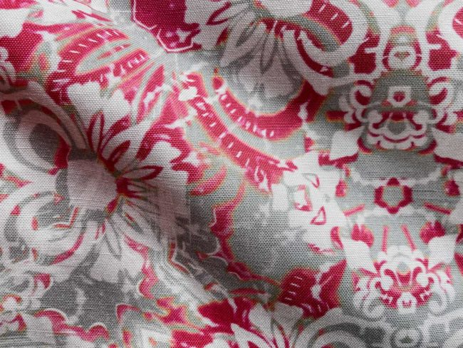 A fabric swatch of Pearl & Maude's abstract floral Carmen in berry magenta and grey