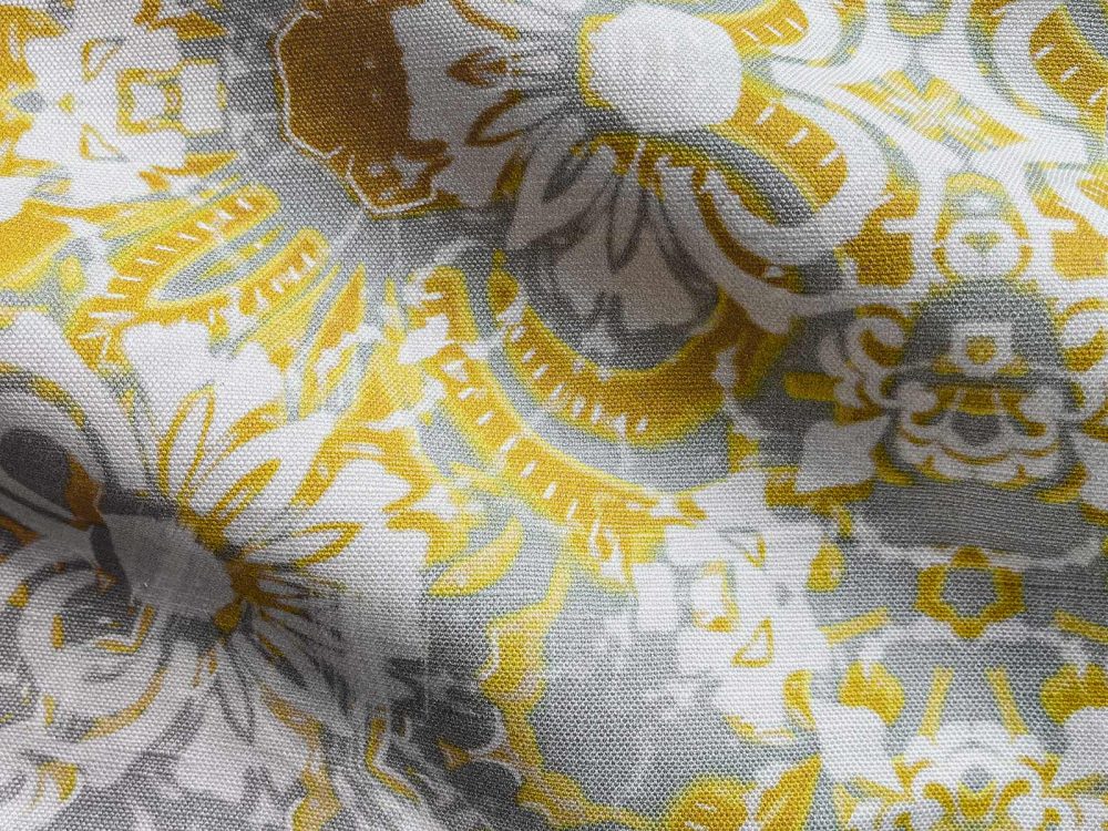 A fabric swatch of Pearl & Maude's abstract floral Carmen in daisy yellow and grey