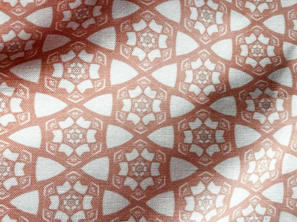 A fabric swatch of Pearl & Maude's small hexagonal pattern Cora in pink and white