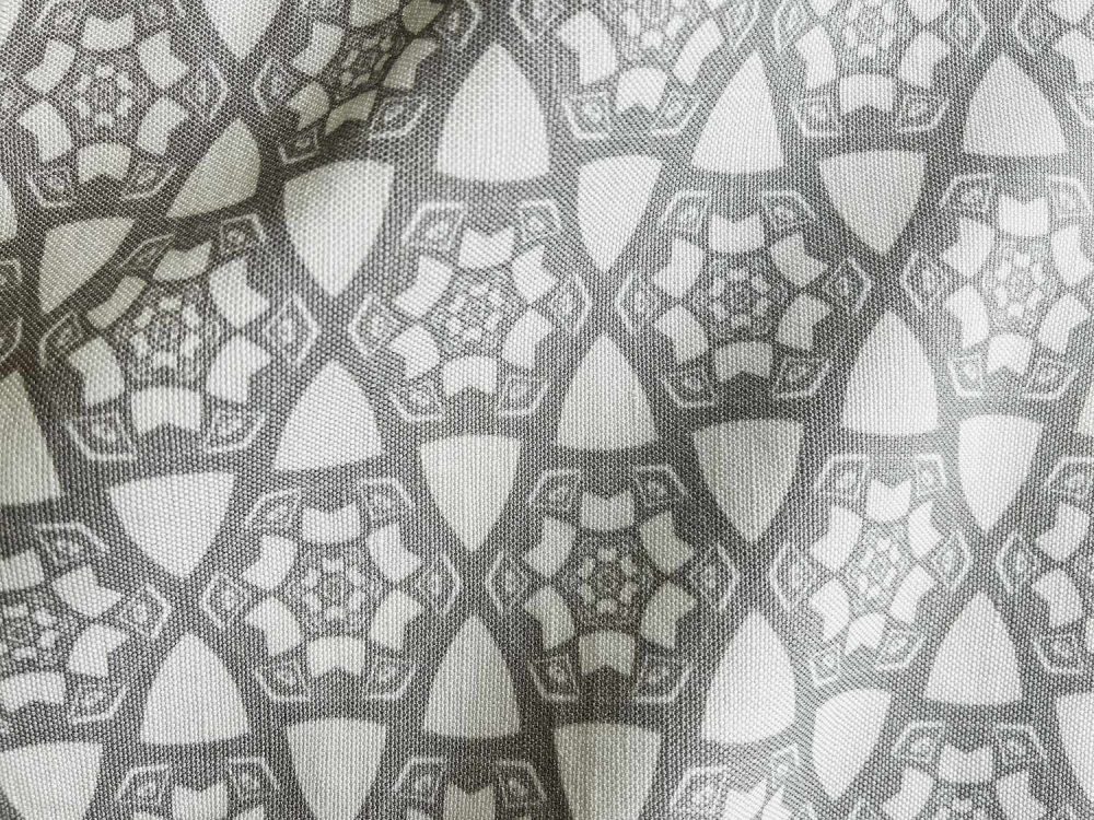 A fabric swatch of Pearl & Maude's small hexagonal pattern Cora in grey and white