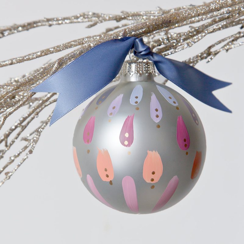 clear dawn hand painted christmas ornament in colors of violet, apricot and periwinkle