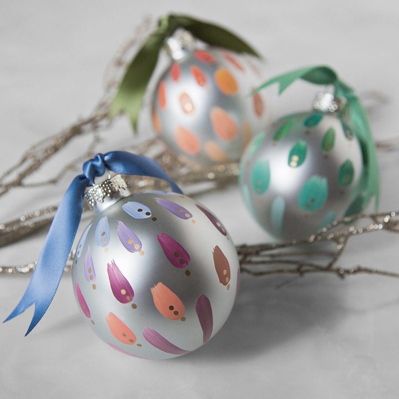A set of three hand painted christmas ornaments in a country inspired, pastel color palette