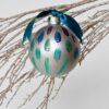 Steppin Out Christmas Tree Ornament is a hand painted glass ornament in shades of aubergine to teal and green