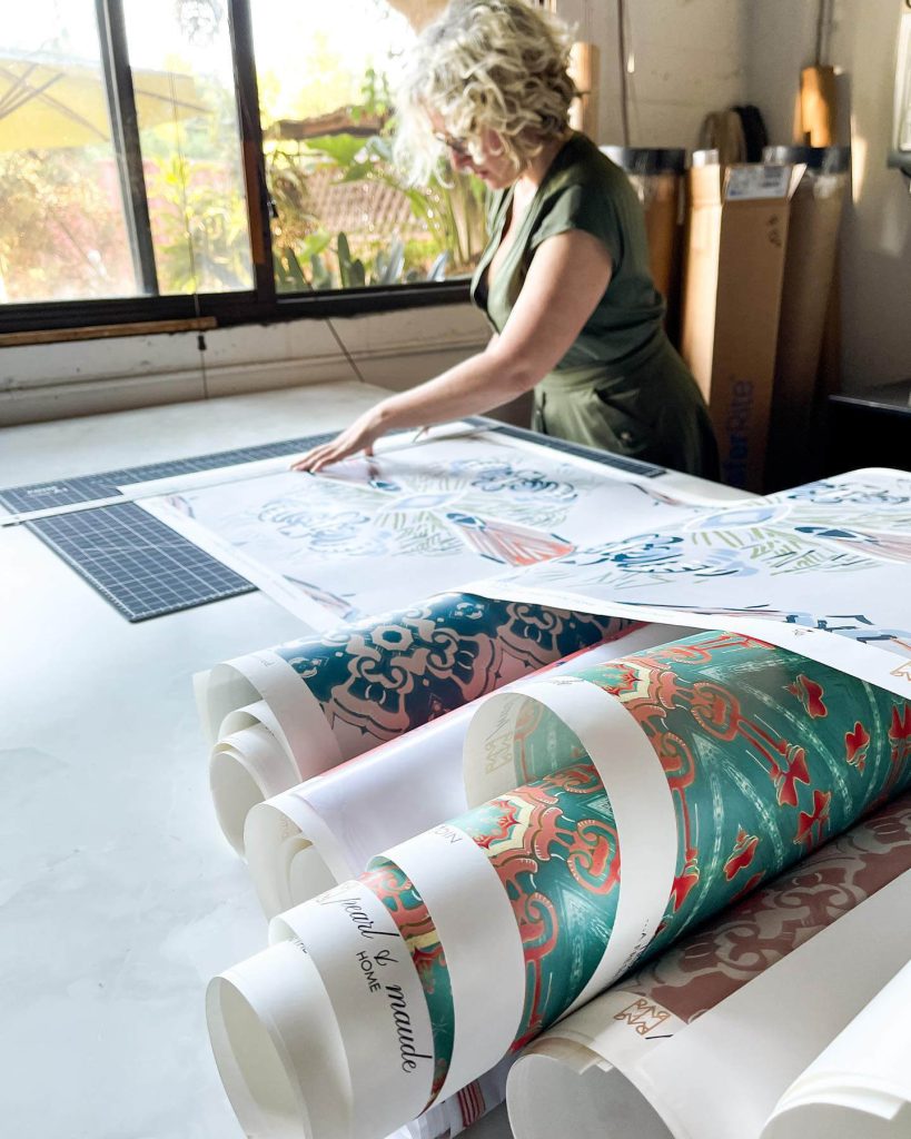 Teale Hatheway, founder of Pearl and Maude working on wallpaper in the studio
