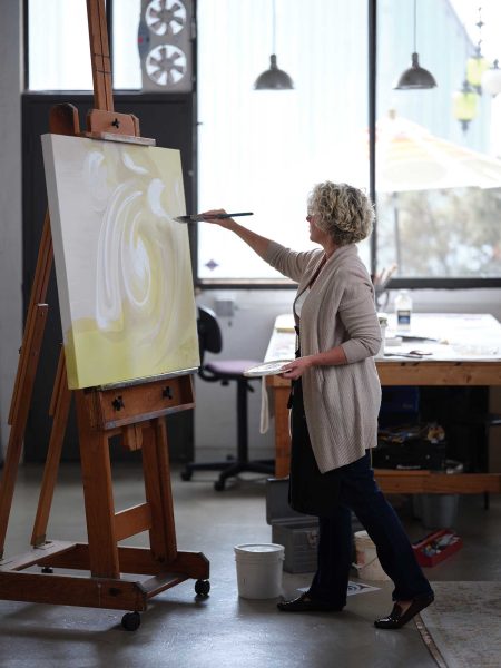 Teale Hatheway painting in her large airy southern California studio