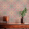 A closeup view of our Beaufort Sunburst Pattern Wallpaper in the Boardwalk colorway of brown and magenta. Installed on the wall of a room decorated with fine wood furniture