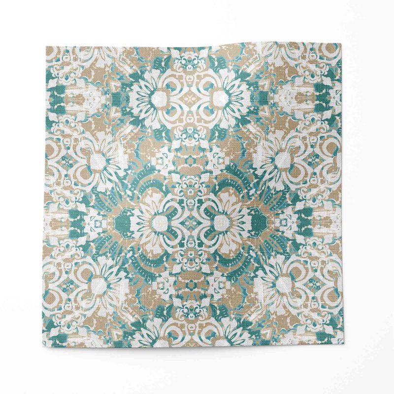A swatch of Carmen Inlay linen fabric in colorway Surf. It is an abstract floral fabric in turquoise, brown and white colors. It's an ideal fabric for draperies.
