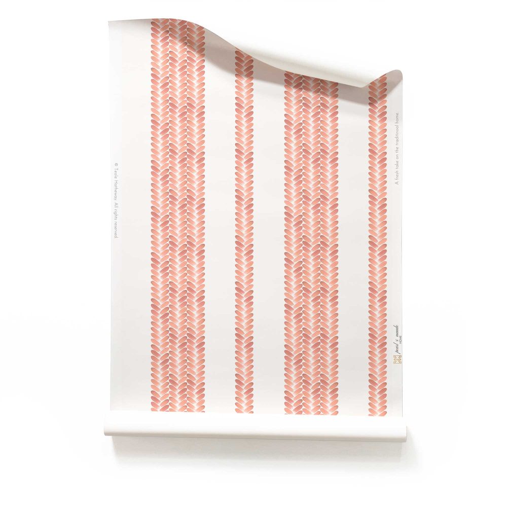 A roll of Perigrene wallpaper in colorway Dawn. It is a woven stripe wallcovering in pink, peach and white colors. It's an ideal wallpaper for bedrooms.