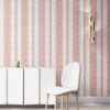 Perigrene wallpaper in colorway Dawn, installed in a bedroom. It's light colors are cheerful. It's pink and peach stripes are tailored and textural.