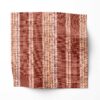 A swatch of Perigrene drapery fabric in colorway Saltillo. It is a woven stripe fabric in pink, peach and red colors. It's an ideal fabric for draperies.
