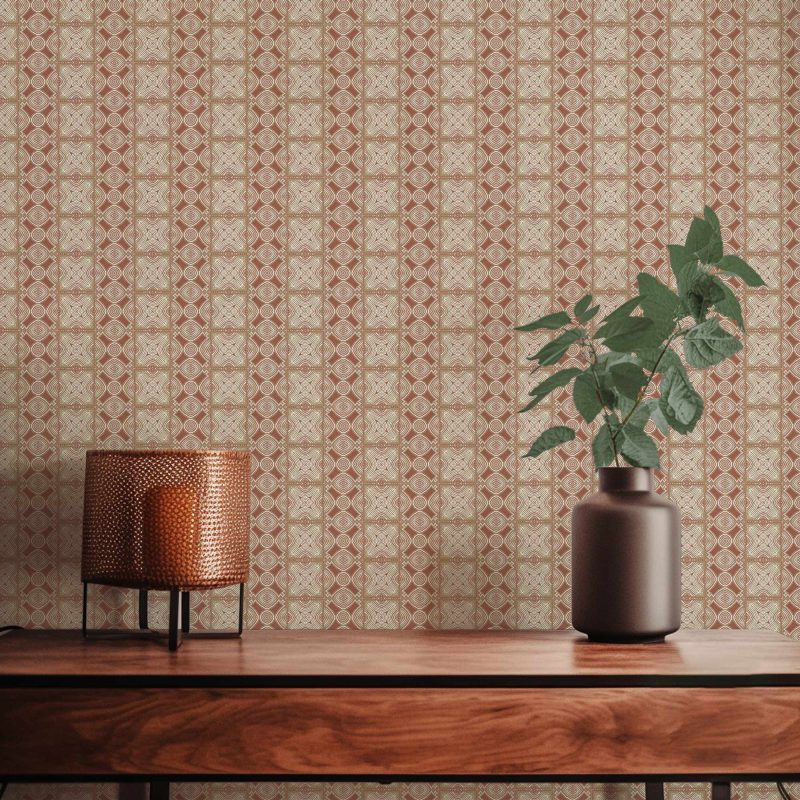 A closeup view of our Ruguru geometric tile wallpaper in the rust red and beige colorway. Installed on the wall of a room decorated with fine wood furniture