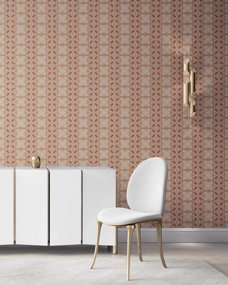 our Ruguru geometric tile wallpaper, with an intricate repeat, in the Rust Red and beige colorway. Installed on the wall of a room interior decorated with fine white velvet seating and high end furniture
