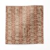 A swatch of "Ruguru" - an enchanting linen fabric pattern that showcases intricate linework, crafting a mesmerizing red tribal patterned fabric in a small, textural pattern.
