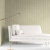 our Ruguru geometric tile wallpaper, in a small repeat, in the Sage Green and beige colorway. Installed on the wall of a room decorated with fine white velvet seating and high end furniture