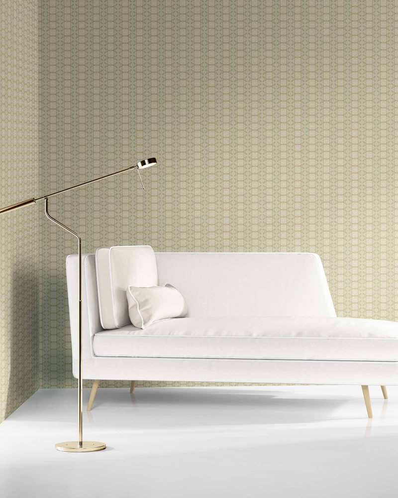 our Ruguru geometric tile wallpaper, in a small repeat, in the Sage Green and beige colorway. Installed on the wall of a room decorated with fine white velvet seating and high end furniture