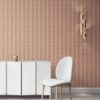 our Ruguru geometric tile wallpaper, with an intricate repeat, in the Rust Red and beige colorway. Installed on the wall of a room interior decorated with fine white velvet seating and high end furniture