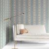 our Ruguru geometric tile wallpaper, with an intricate repeat, in the Spring Blue and beige colorway. Installed on the wall of a room decorated with fine white velvet seating and high end furniture