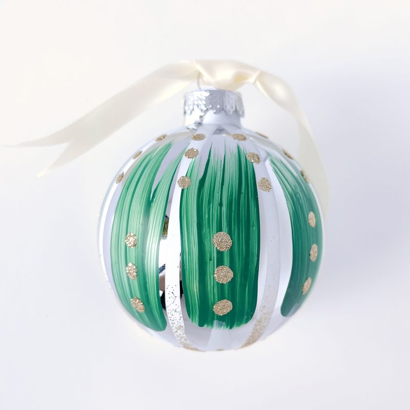 Hand painted Christmas ornament in green and white with gold glitter and ivory satin ribbon.