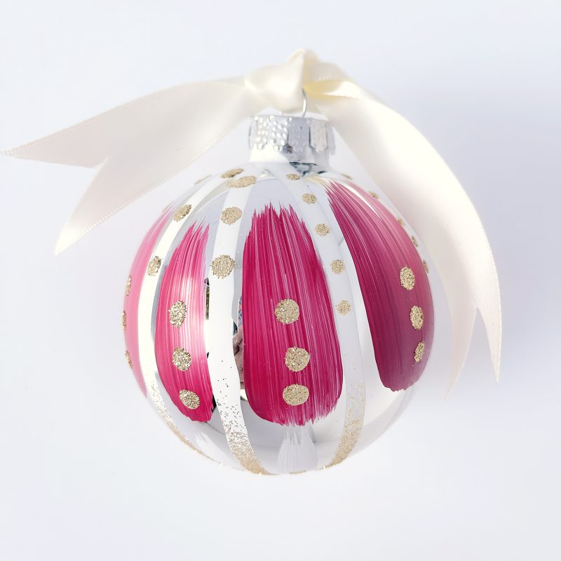 Hand painted Christmas ornament in magenta and white with gold glitter and ivory satin ribbon.