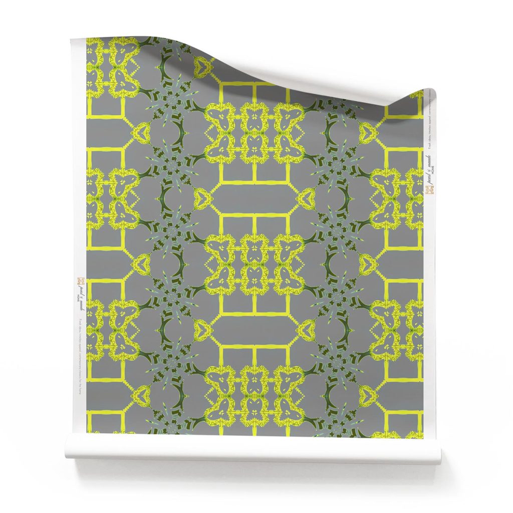 Roll of grey modern Chinoiserie wallpaper with lime trellis patterns in chartreuse and yellow on a dark grey background.. Design - Arachne by Pearl and Maude