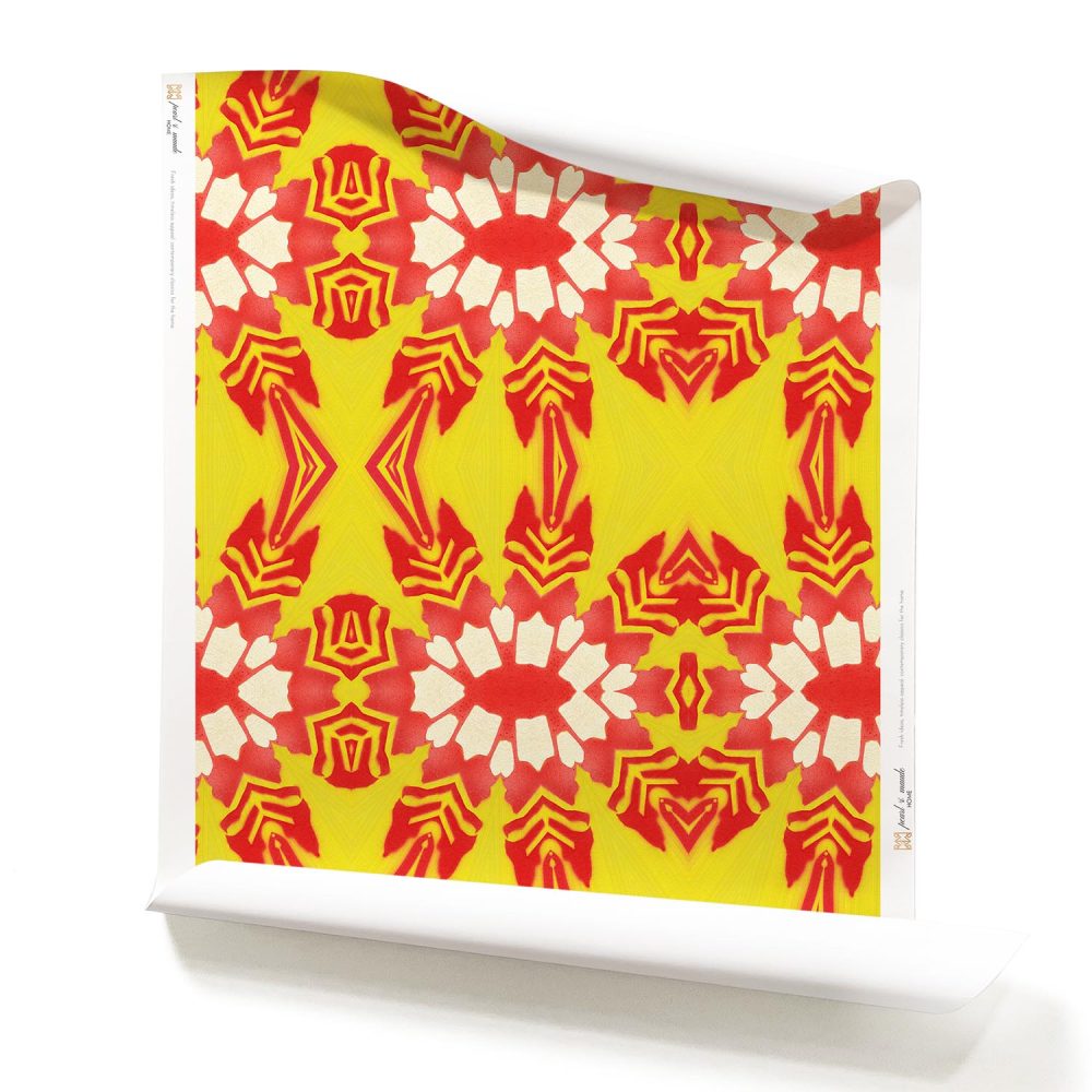 A roll of Artemis, Pearl & Maude's yellow and red tropical wallpaper in playful and bold colors