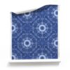 A roll of "Beaufort,” our blue starburst wallpaper, in the indigo blue and white colorway, draws inspiration from the laid-back, bohemian beach bungalows of 1960s Southern California.