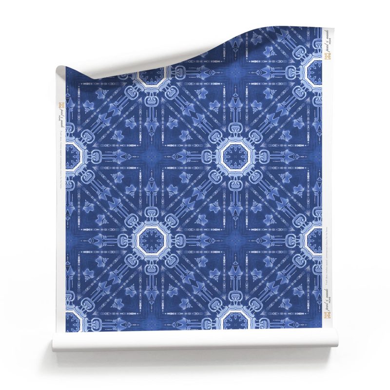 A roll of "Beaufort,” our starburst pattern wallpaper, in the indigo blue and white colorway, draws inspiration from the laid-back, bohemian beach bungalows of 1960s Southern California.