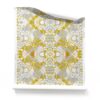 a roll of Carmen yellow and white floral botanical wallpaper. It is a light, airy pattern wallpaper, underpinned with layers of grey and white.