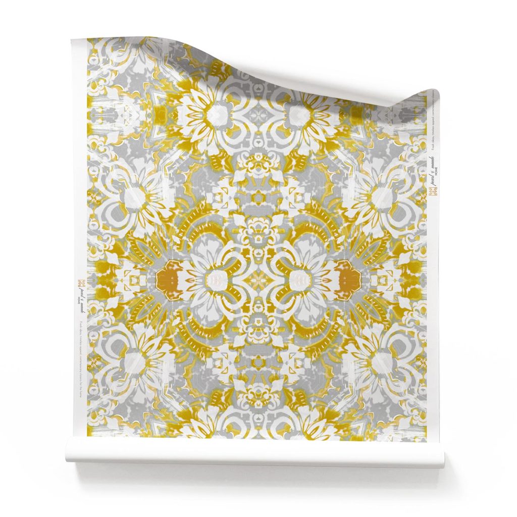 a roll of Carmen yellow and white floral botanical wallpaper. It is a light, airy pattern wallpaper, underpinned with layers of grey and white.