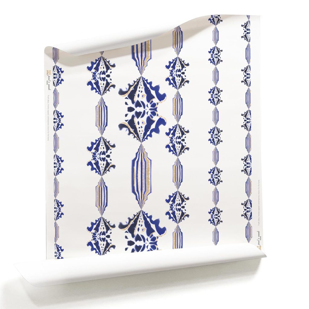 Charlie Sapphire blue and white striped wallpaper with flowers_a white artisan wallpaper_Pearl and Maude. A roll of Charlie, Pearl & Maude's blue and white floral striped wallpaper has a vintage wallpaper motif