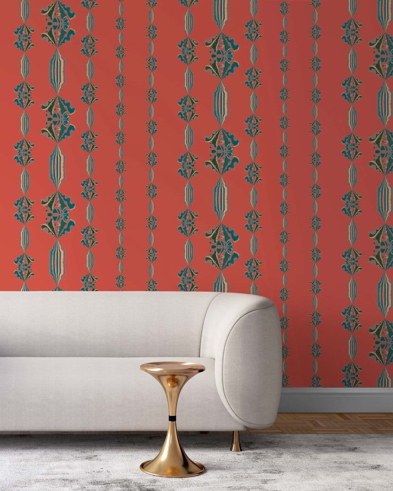 Charlie rust red floral striped wallpaper installed in a living room with a cream colored sofa