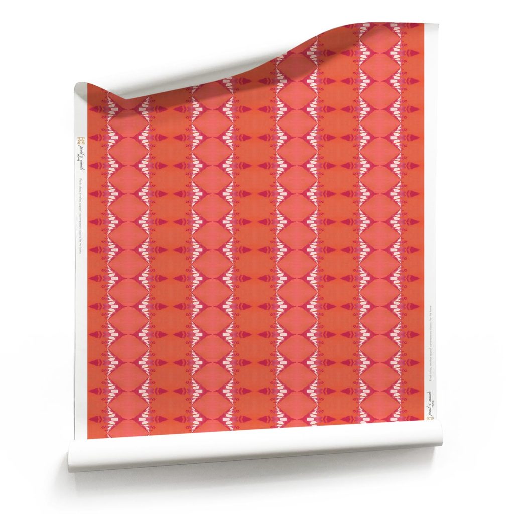 Roll of striped Ikat Wallpaper in Magenta and coral, orange and fuchsia striped wallpaper on classic matte wallpaper roll. A red artisan wallpaper. Design - Evelyn by Pearl and Maude. Roll of Abstract Ikat Wallpaper with Magenta and Coral Stripes - on clay coated wallpaper roll. Design - Evelyn by Pearl and Maude