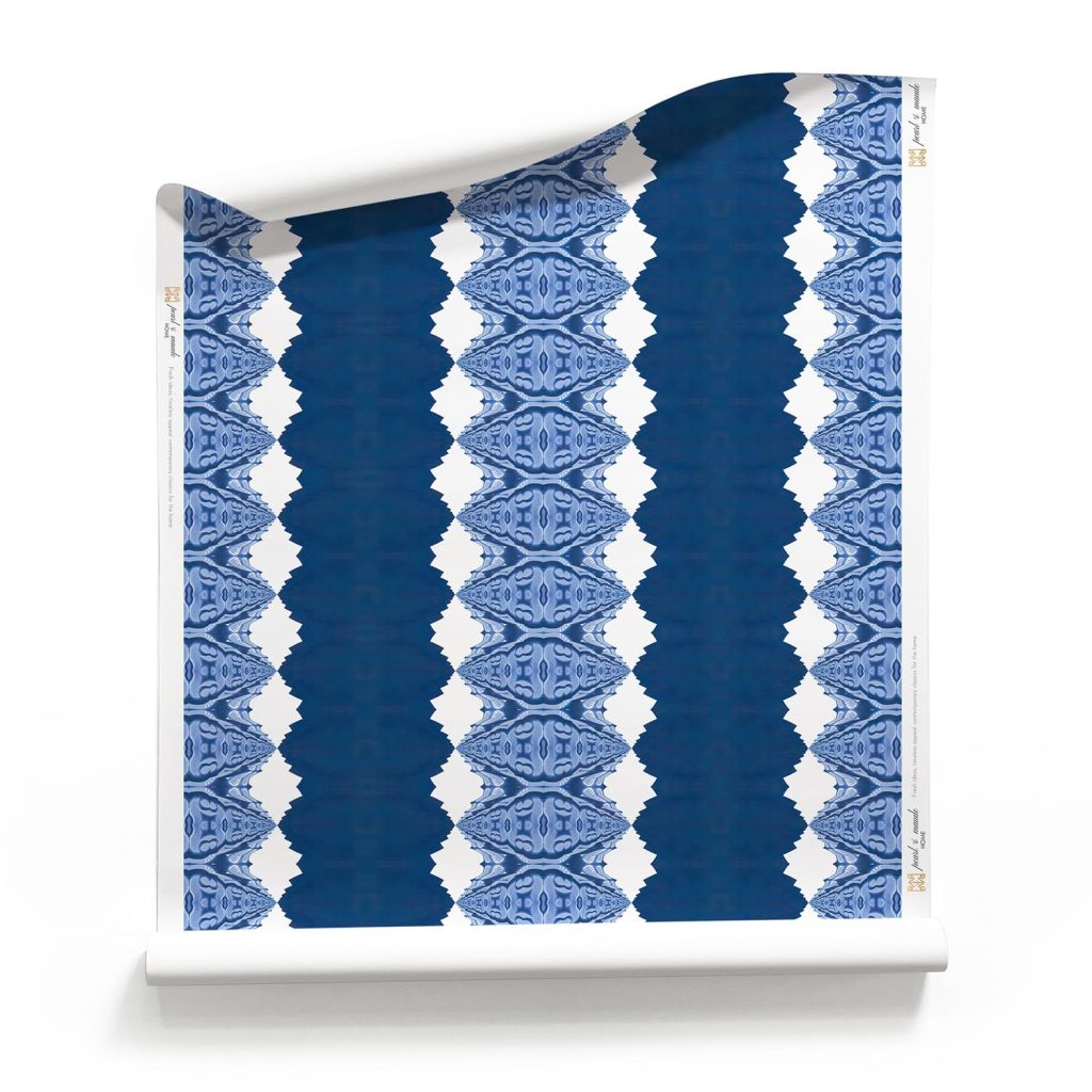 A roll of Lou Striped Navy Blue Wallpaper on a white background- sustainable artisan wallpaper with a nautical stripe theme. _Pearl and Maude. Lou Navy Blue Stripe Wallpaper Roll