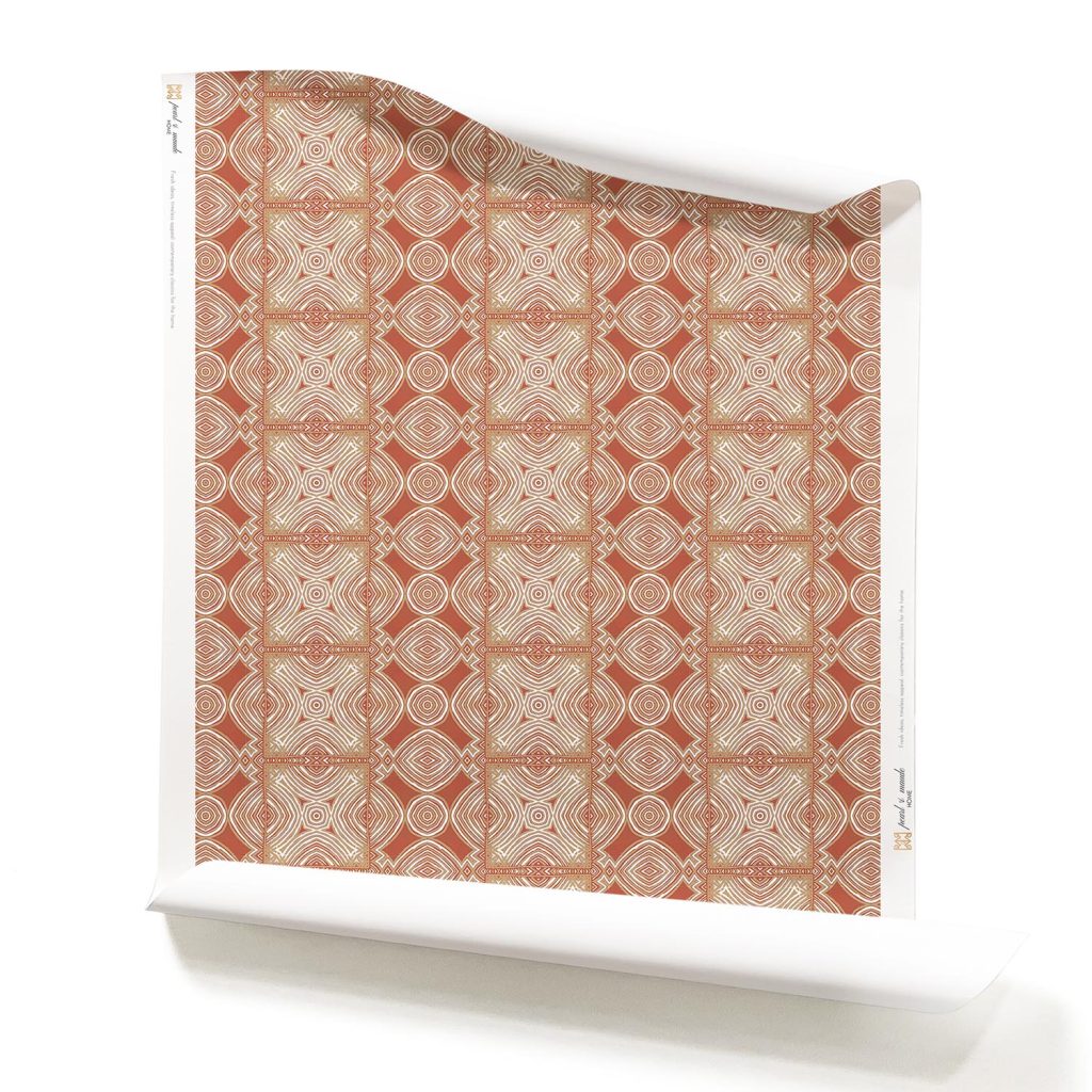 A roll of Ruguru Brick Red Art Deco Wallpaper, with intricate patterns, in rust, white and brown.