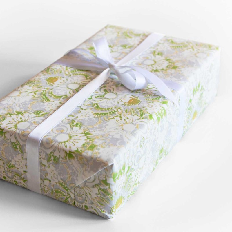A gift wrapped with Carmen lime green floral wrapping paper