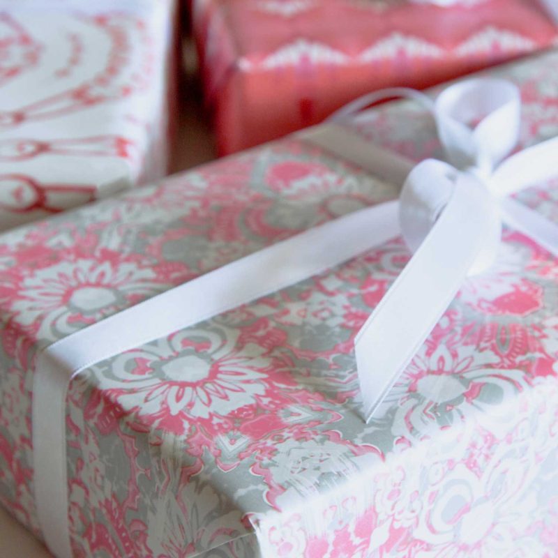 A gift wrapped in Carmen pink foliage gift wrapping paper