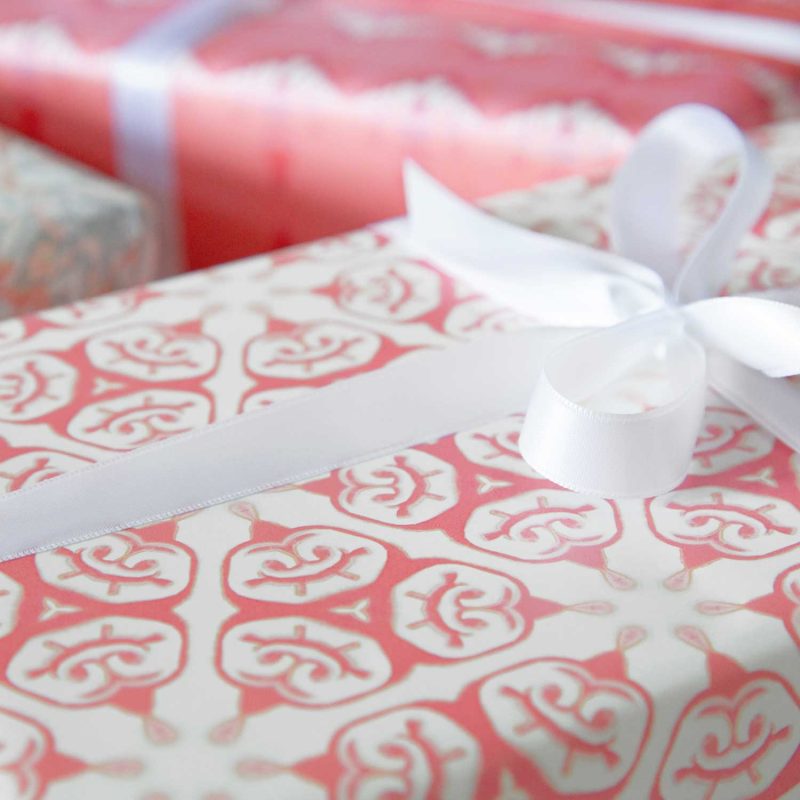 a gift wrapped with Tulia coral and white chinoiserie gift wrap