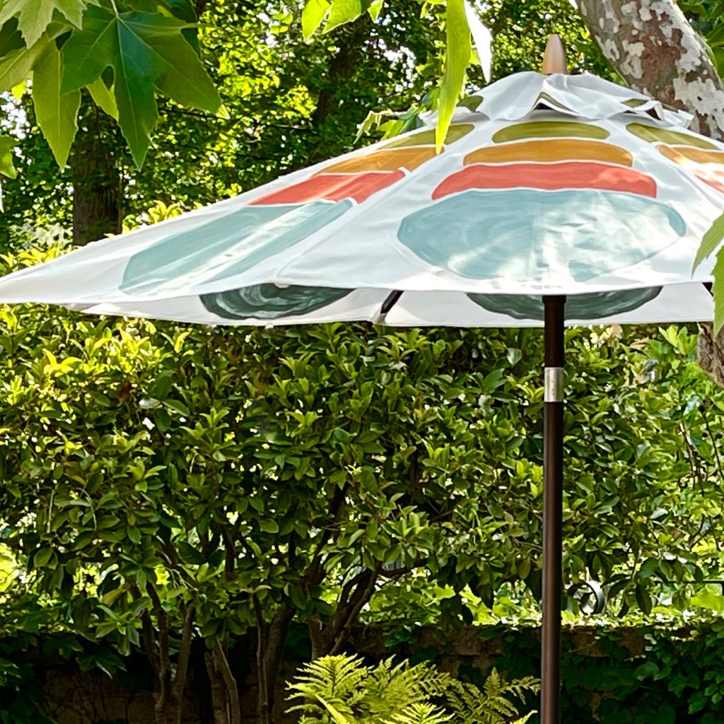 hand painted patio umbrella in ping pong pattern, by artist Teale Hatheway in beautiful summer colors